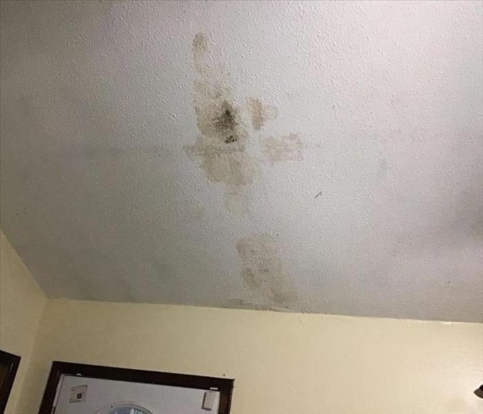 white ceiling with brown water damage stains