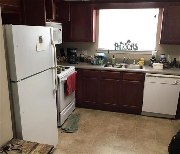 white refrigerator in kitchen with dark wood cabinetry