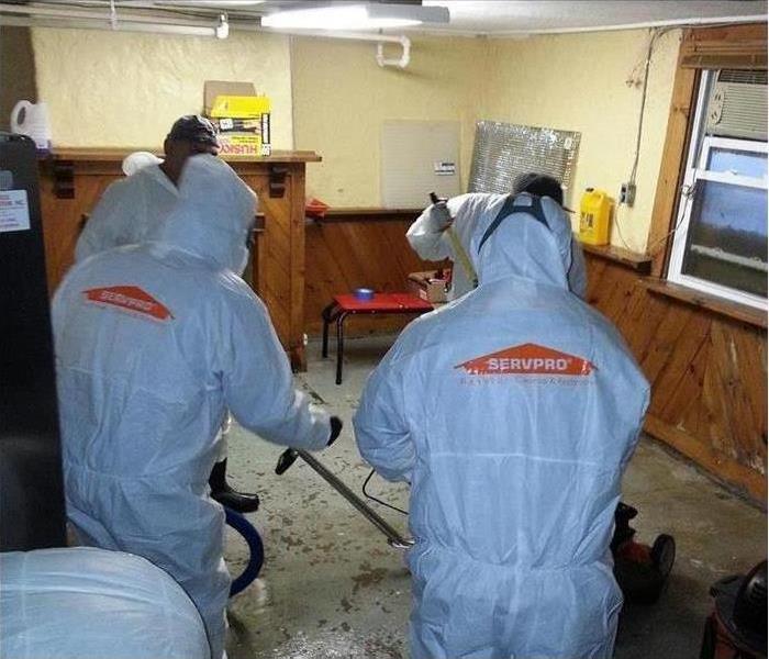 2 employees in biohazard suits